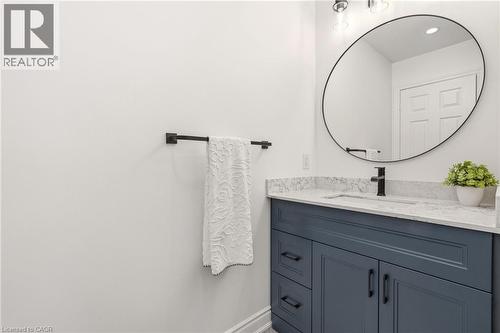 Bathroom vanity featuring a quartz countertop, undermount sink, and matte black faucet - 2089 Broadleaf Crescent, Burlington, ON 
