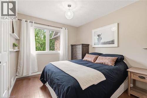 Bedroom featuring warm neutral wall tones and wood-finish flooring - 2089 Broadleaf Crescent, Burlington, ON 