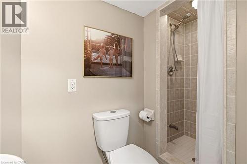 Tiled shower enclosure featuring a multi-function showerhead and integrated shelving - 2089 Broadleaf Crescent, Burlington, ON 