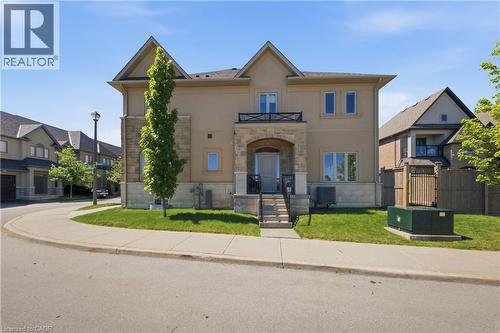 Stucco exterior with stone accents and a covered porch entrance - 104 Sonoma Valley Crescent, Hamilton, ON - Outdoor With Facade