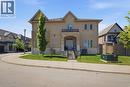 Stucco exterior with stone accents and a covered porch entrance - 104 Sonoma Valley Crescent, Hamilton, ON  - Outdoor With Facade 