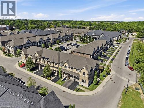 Aerial perspective showcasing a residential community with townhomes featuring varied facades - 104 Sonoma Valley Crescent, Hamilton, ON - Outdoor With View