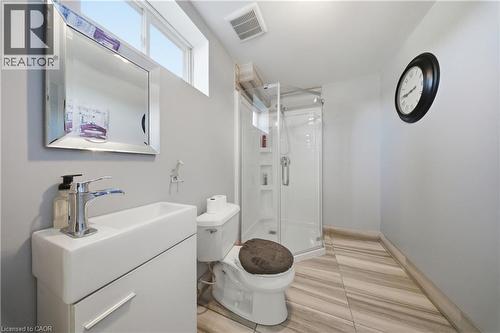 Contemporary bathroom featuring a white vanity with integrated sink, chrome faucet, and a wall-mounted mirror - 104 Sonoma Valley Crescent, Hamilton, ON - Indoor Photo Showing Bathroom