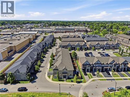 Aerial representation of a residential community featuring townhomes with gabled roofs and private driveways - 104 Sonoma Valley Crescent, Hamilton, ON - Outdoor With View