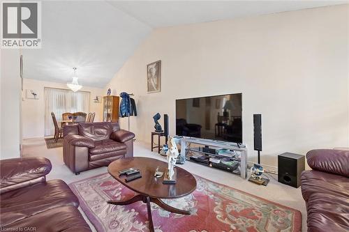 Vaulted ceiling in the living area featuring neutral wall tones and carpet flooring - 176 Sandford Fleming Drive, Waterloo, ON - Indoor Photo Showing Living Room