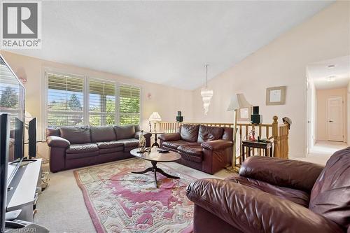 Living area featuring a vaulted ceiling with a prominent chandelier - 176 Sandford Fleming Drive, Waterloo, ON - Indoor Photo Showing Living Room