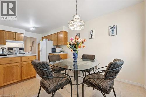 Kitchen with light wood cabinetry, white countertops, and tile flooring - 176 Sandford Fleming Drive, Waterloo, ON - Indoor