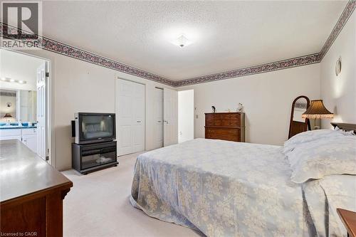 Carpeted bedroom with a flat white ceiling, white walls, and decorative wallpaper border - 176 Sandford Fleming Drive, Waterloo, ON - Indoor Photo Showing Bedroom