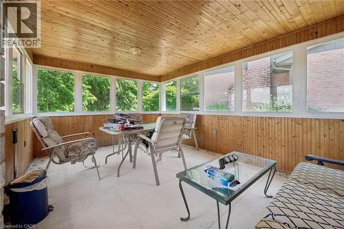 Enclosed porch featuring paneled wood walls and ceiling, multiple windows, and a light-colored floor - 176 Sandford Fleming Drive, Waterloo, ON - Outdoor With Deck Patio Veranda With Exterior