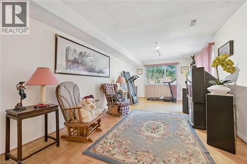 Spacious room featuring wood-finish flooring and a large window with vertical blinds - 176 Sandford Fleming Drive, Waterloo, ON - Indoor Photo Showing Other Room