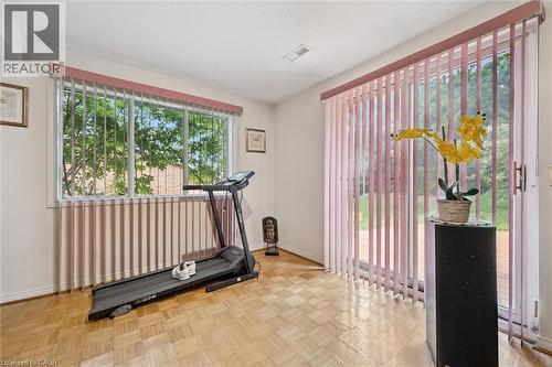 Bright interior space featuring a large window and glass sliding door, both equipped with vertical blinds - 176 Sandford Fleming Drive, Waterloo, ON - Indoor Photo Showing Other Room