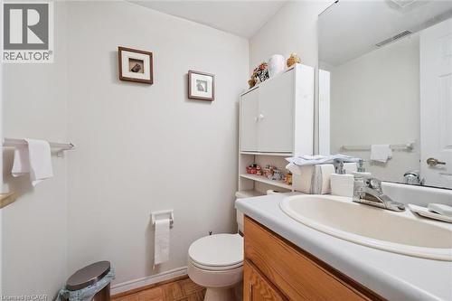 Bathroom featuring a wood-finish flooring, white walls, and a built-in vanity with a laminate countertop and undermount sink - 176 Sandford Fleming Drive, Waterloo, ON - Indoor Photo Showing Bathroom