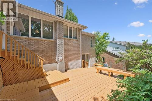 Expansive wood-finish deck with integrated seating, featuring direct access to the interior and exterior - 176 Sandford Fleming Drive, Waterloo, ON - Outdoor With Deck Patio Veranda With Exterior