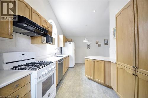 Kitchen featuring light wood cabinetry, white countertops, tile backsplash, and stainless steel dishwasher - 95 Drinkwater Drive, Cambridge, ON - Indoor Photo Showing Kitchen