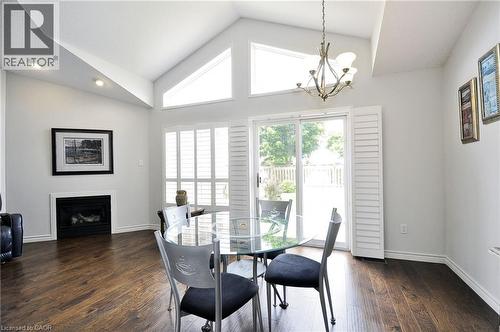 Vaulted ceiling interior with wood-finish flooring - 95 Drinkwater Drive, Cambridge, ON - Indoor Photo Showing Dining Room With Fireplace