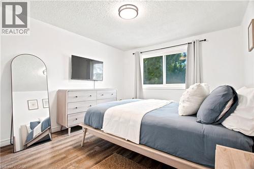 Bedroom with wood-finish flooring, a double window, and a flush-mount ceiling light fixture - 175 Siebert Avenue Unit# 9, Kitchener, ON 