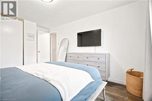 Hardwood-finish flooring, white walls, and a built-in closet with sliding doors - 175 Siebert Avenue Unit# 9, Kitchener, ON 