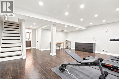 Spacious lower-level area featuring recessed lighting, wood-finish flooring, light grey wall tones, and a staircase with dark treads and white risers - 175 Siebert Avenue Unit# 9, Kitchener, ON 