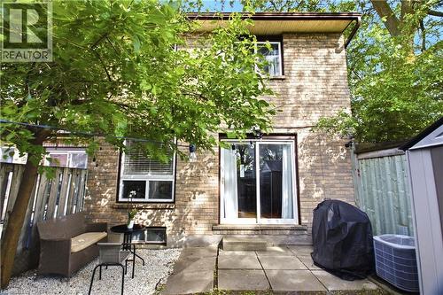 Brick exterior featuring two levels, a sliding patio door, and a ground-floor window with blinds - 175 Siebert Avenue Unit# 9, Kitchener, ON 
