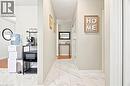 Tiled hallway featuring light-toned walls and crown molding - 175 Siebert Avenue Unit# 9, Kitchener, ON 