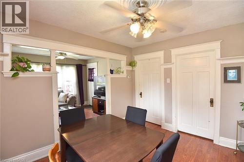 Dining area with wood-finish flooring and a central ceiling fan with integrated lighting - 56 Barons Avenue N, Hamilton, ON 