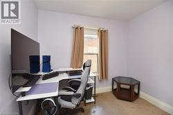 Compact room with light purple walls and carpeted flooring - 