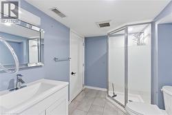Bathroom featuring a vanity with an integrated sink, polished chrome faucet, and a framed mirror - 