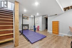 Finished basement featuring light wood-finish flooring, recessed lighting, and painted walls - 