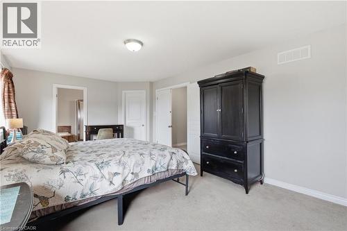 Carpeted room with light gray walls, a flush-mount ceiling light, and white trim - 84 Duncairn Crescent, Hamilton, ON 