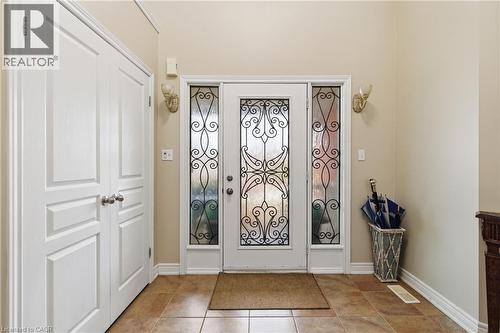 Entryway featuring a decorative glass front door with ornate wrought iron detailing and matching sidelights - 84 Duncairn Crescent, Hamilton, ON 