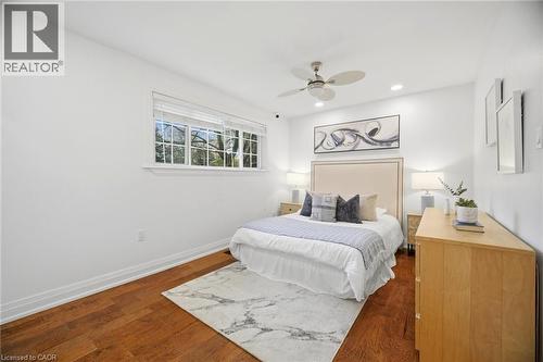 Hardwood-style flooring throughout with a marble-patterned area rug - 1376 Royal Drive, Burlington, ON 