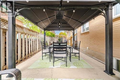 Expansive concrete patio featuring a permanent gazebo with built-in string lighting - 1376 Royal Drive, Burlington, ON 
