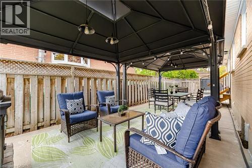 Paved patio with a black gazebo featuring integrated lighting fixtures - 1376 Royal Drive, Burlington, ON 