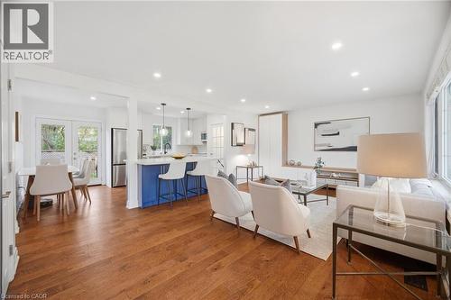 Open-concept living area with wood-finish flooring, recessed lighting, and white walls - 1376 Royal Drive, Burlington, ON 