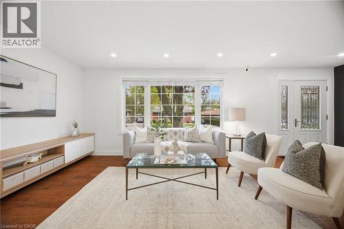 Bright living area with wood-finish flooring, recessed lighting, and a prominent bay window - 1376 Royal Drive, Burlington, ON 
