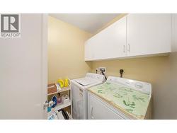 A laundry ROOM (not stuck doing laundry out of a closet). Room for a fridge/freezer as well. - 