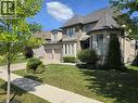 Stone and stucco exterior featuring a turret detail, multiple gables, and a two-car garage - 2719 Torrey Pines Way, London, ON 