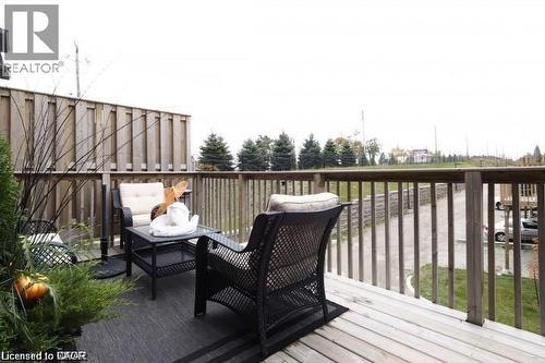Outdoor deck featuring natural wood planks and matching wood railings - 4 Isaiah Drive, Kitchener, ON 