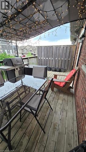 Rear deck featuring wood planks and a privacy fence - 4 Isaiah Drive, Kitchener, ON 