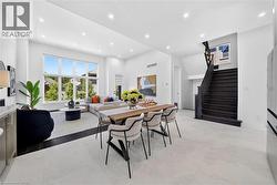 Open-concept living space with large windows, recessed lighting, and high ceilings - 