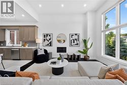 Living room featuring a two-story window, recessed lighting, and a floor-to-ceiling fireplace - 