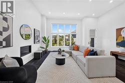 Bright living area featuring high ceilings and dark wood-finish flooring - 