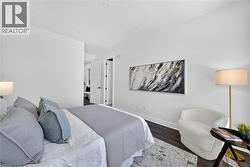 Bright interior room featuring wood-finish flooring, white walls, and recessed lighting - 
