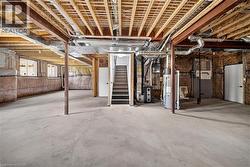 Spacious unfinished basement with concrete flooring and exposed ceiling joists - 