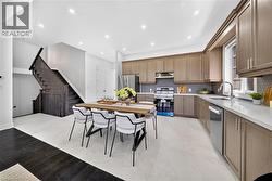 Kitchen featuring extensive cabinetry, stainless steel appliances, and a hexagonal tile backsplash - 
