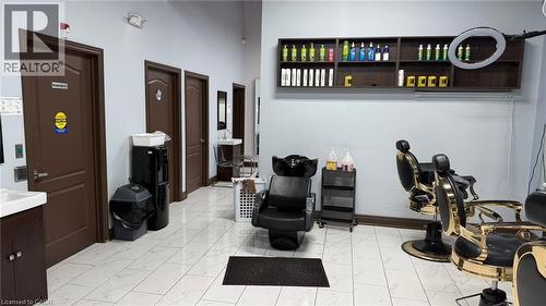 Commercial interior featuring light-colored tile flooring, multiple dark brown doors, and light blue wall paint - 9 Beaumaris Drive Unit# B4, Brampton, ON 
