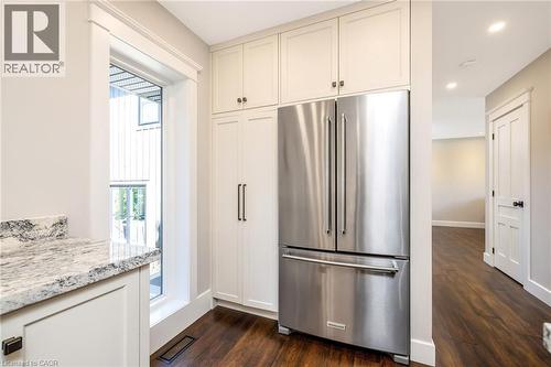 Stainless steel French door refrigerator set within white shaker cabinetry - 23 Mackenzie Drive, Georgetown, ON 