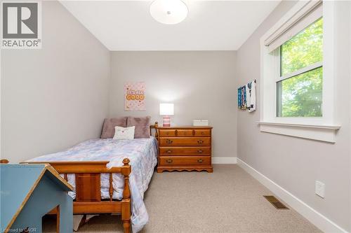 Neutral toned bedroom featuring light grey walls and beige carpet flooring - 23 Mackenzie Drive, Georgetown, ON 