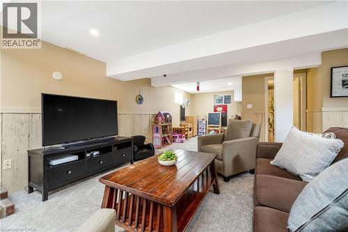 Finished lower-level space featuring recessed lighting, carpeting, and wainscoting - 23 Mackenzie Drive, Georgetown, ON 