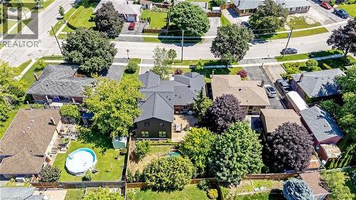 Aerial view showcasing a residential property with a dark-pitched roof, surrounded by mature trees - 23 Mackenzie Drive, Georgetown, ON 